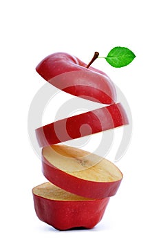 Sliced red apple with green leaf