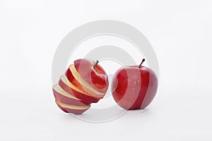 Sliced red apple and whole red apple