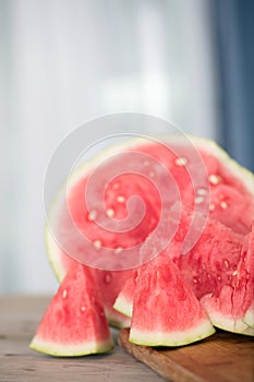 Sliced red-fleshed watermelon on table