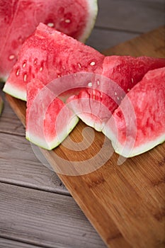 Sliced red-fleshed watermelon on table