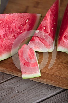 Sliced red-fleshed watermelon on table