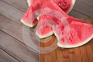 Sliced red-fleshed watermelon on table