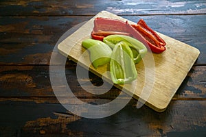 Sliced red and green bell peppers on a cutting board. Organic food and coocking.
