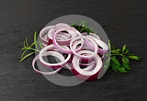 Sliced Red Onion or Purple Onion Rings on Black Background