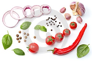 sliced red onion, red hot chili pepper, tomato, garlic and spices isolated on white background. top view