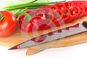 Sliced red ripe fresh pepper on cutting board