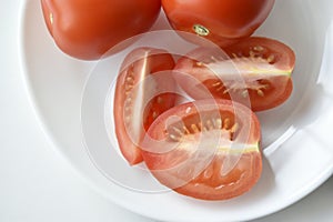 Sliced red tomatoes close-up on a plate