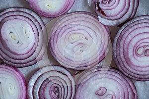 Sliced rings of blue onion as background