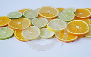 Sliced rings of orange and lemon, and lime isolated on white background