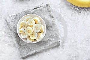 Sliced ripe banana in bowl.