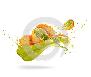 Sliced ripe Kiwano melon Cucumis metuliferus with splash of fresh juice isolated on white background