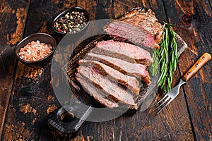 Sliced Roast beef sirloin tri tip steak bbq. Dark wooden background. Top view