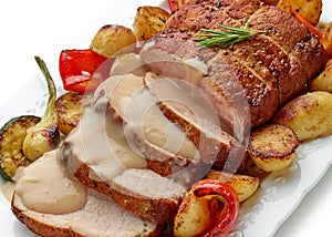 sliced roast pork with vegetables and sauce