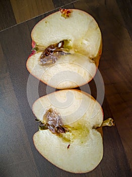 Sliced rotten apple on kitchen worktop
