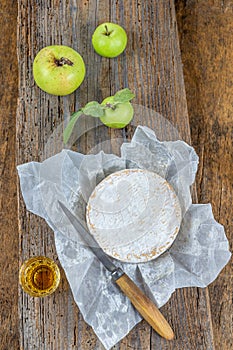 Sliced round camembert cheese traditional french milk creamy dairy product with fresh aromatics herbs