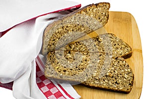 Sliced rye bread on cutting board. Whole grain rye bread with seeds. Delicious whole grain bread.