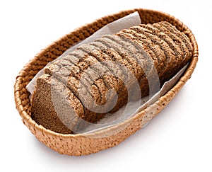 Sliced rye bread in a wicker basket, isolated on a white background