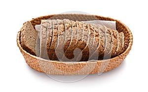 Sliced rye bread in a wicker basket, isolated on a white background