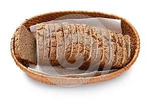 Sliced rye bread in a wicker basket, isolated on a white background
