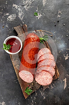 Sliced salami on cutting board. organic products concept. vertical image. top view. copy space for text
