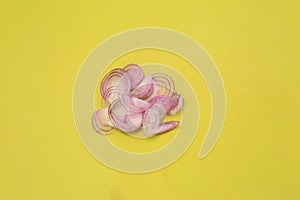 Sliced shallot red onion on green plastic chopping board