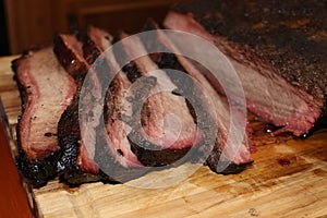 Sliced smoked beef brisket with juices.