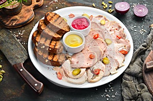 Sliced smoked meat and salami with sauce on a white plate.