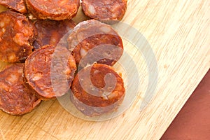 Sliced spanish chorizo sausage on rustic board