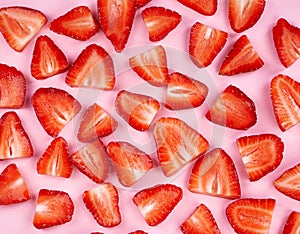 Sliced strawberry on pink background