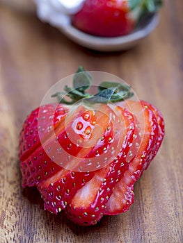 Sliced strawberry on wooden background