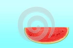 Sliced sweet watermelon isolated over cyan background with copy space