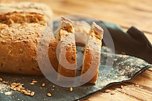 Sliced tasty bread on wooden table, closeup