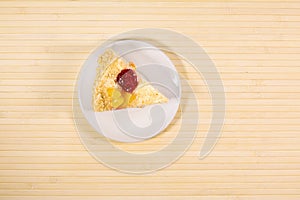 Sliced tasty cake with straberry and peach on wooden background