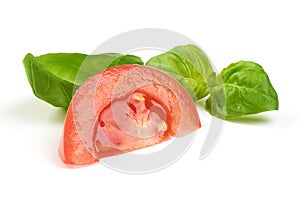 Sliced tomat and fresh green basil isolated on white