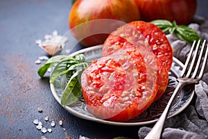 Sliced tomato on blue rusty background