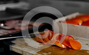 Sliced tomatoes on a cutting table photo