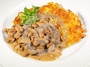 Sliced Turkey Meat Zurich Style with Potato Roesti - Isolated