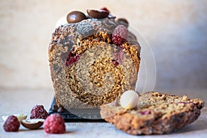 Sliced vanilla cake with chocolates and raspberry.  Close up