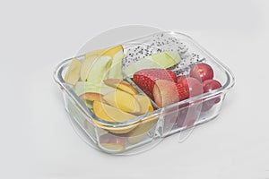 Sliced various fruit combinations are placed in glass containers and placed on a white background.