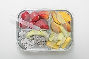Sliced various fruit combinations are placed in glass containers and placed on a white background.