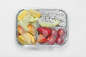 Sliced various fruit combinations are placed in glass containers and placed on a white background.