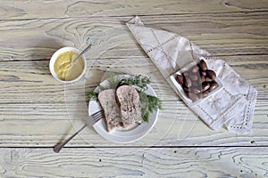 Sliced veal tongue on a white plate