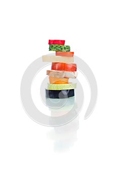 Sliced vegetables arranged in a column isolated on white