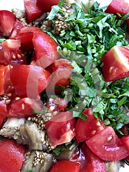 Sliced vegetables: baked aubergines, fresh tomatoes, parsley.