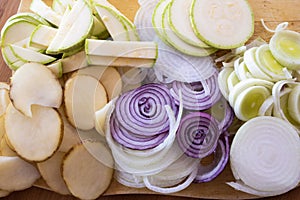 Sliced vegetables, cut vegetables on wooden background. Veggies cooking ingredients, top view, copy space