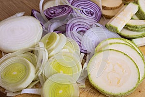 Sliced vegetables, cut vegetables on wooden background. Veggies cooking ingredients, top view, copy space