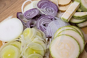 Sliced vegetables, cut vegetables on wooden background. Veggies cooking ingredients, top view, copy space