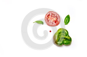 Sliced vegetables tomato and pepper and paprika and salad and Basil and pepper peas on white background