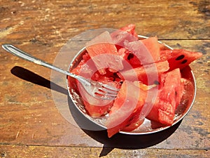 Sliced watermelon with cork in a mini plate