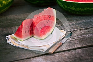 Sliced watermelon on plate with knife